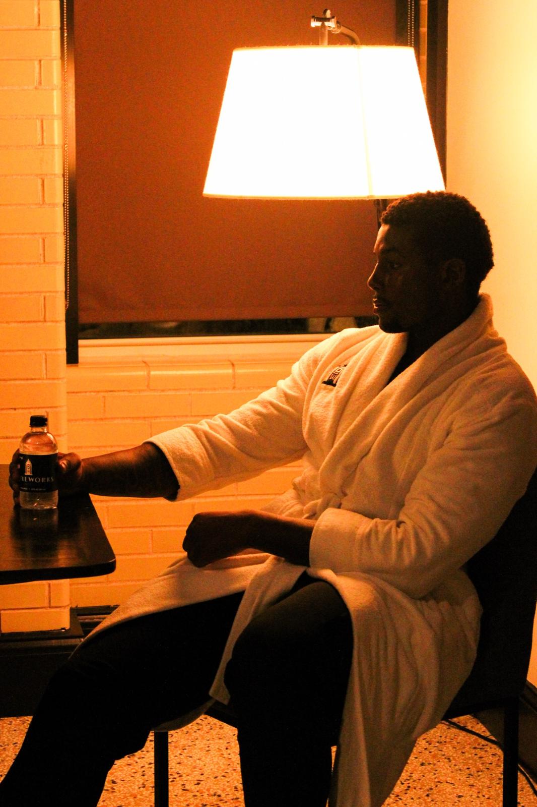 Model in a Bottleworks robe reading by lamplight